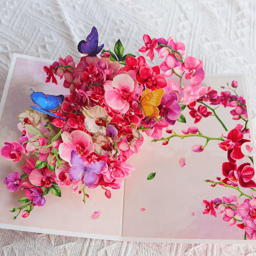Floral orchid greeting card, open, dense pink blossoms with butterflies and green leaves