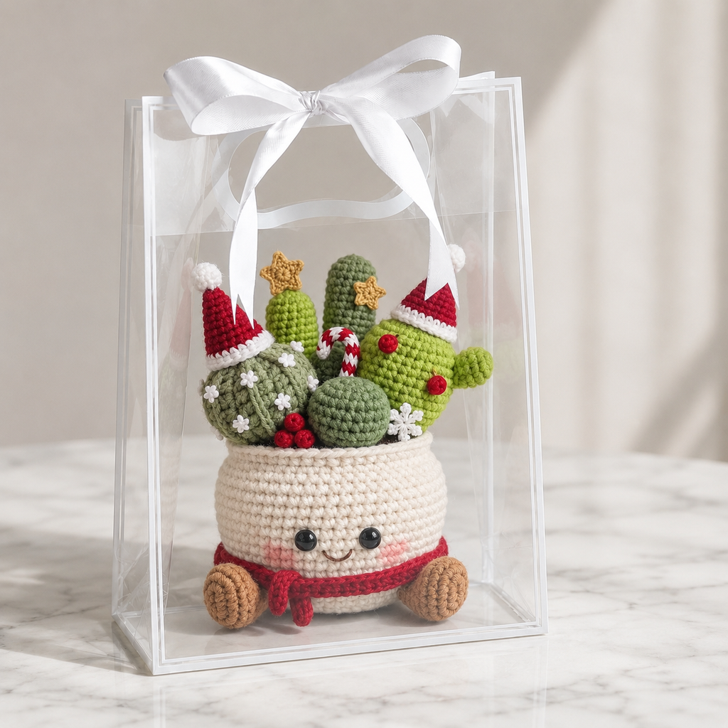 Crocheted amigurumi cactus decor in cream pot with smiling face, red scarf