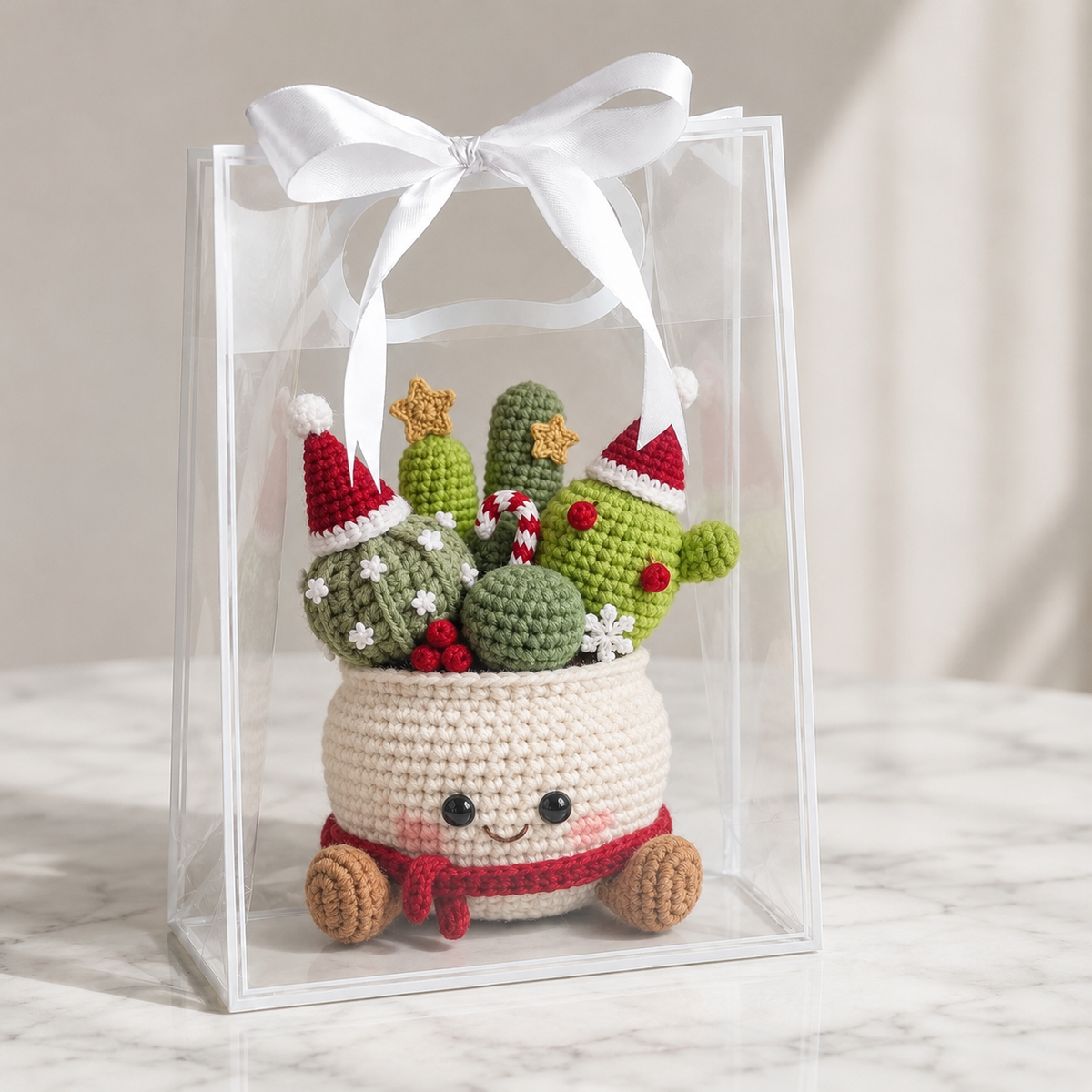Crocheted amigurumi cactus decor in cream pot with smiling face, red scarf