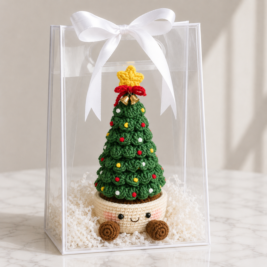 Crochet Christmas tree in clear gift box, green layers with smiling cream pot base and ribbon bow