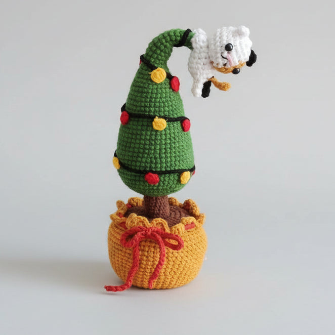 Crocheted amigurumi figurine with green body, yellow pot, and small white panda face