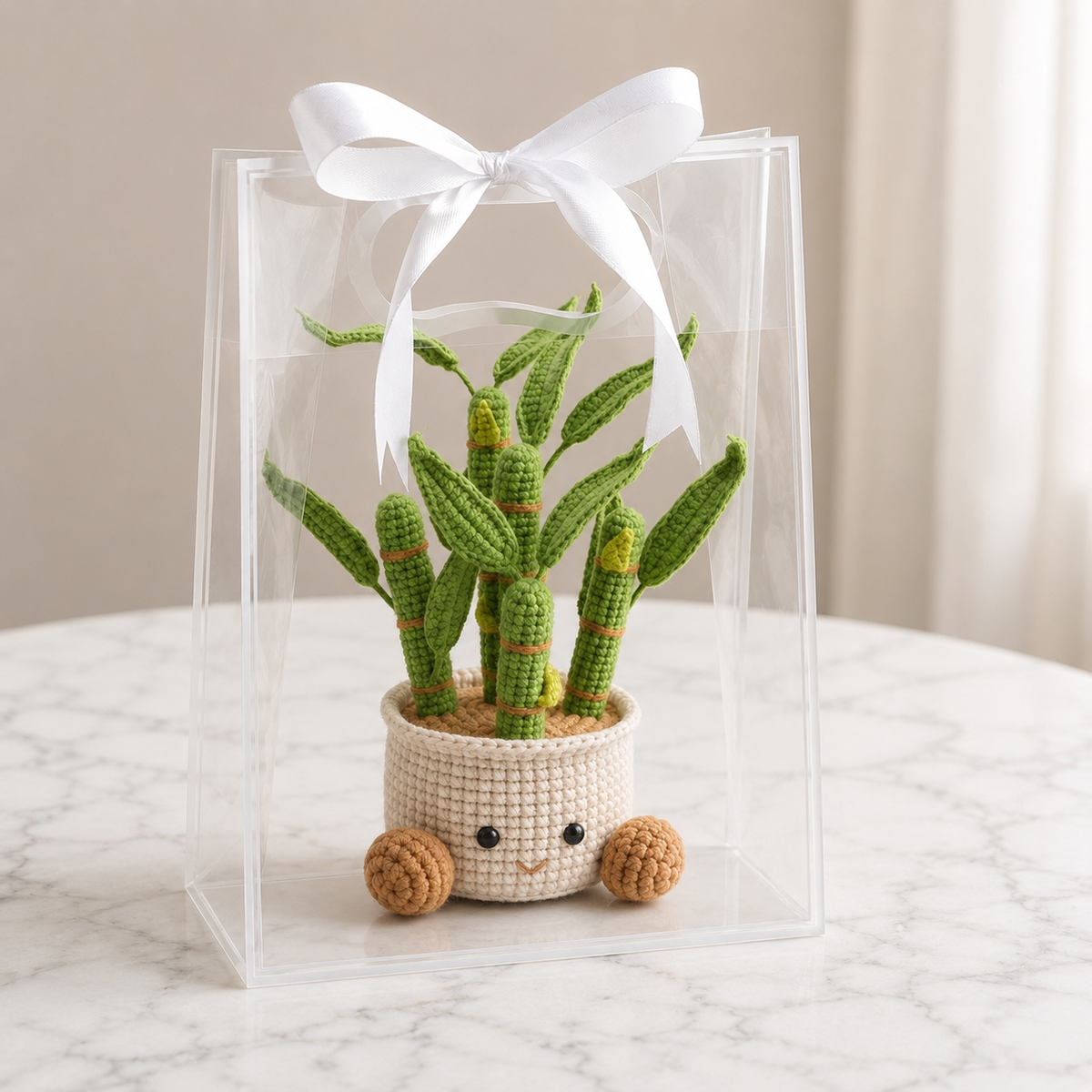 Handmade crochet potted plant with green cacti stems and a beige pot with cute face