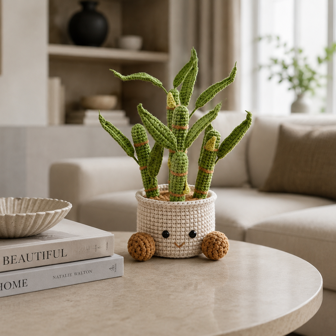 Handmade crochet potted plant with green cactus-like stems in beige pot with cute face