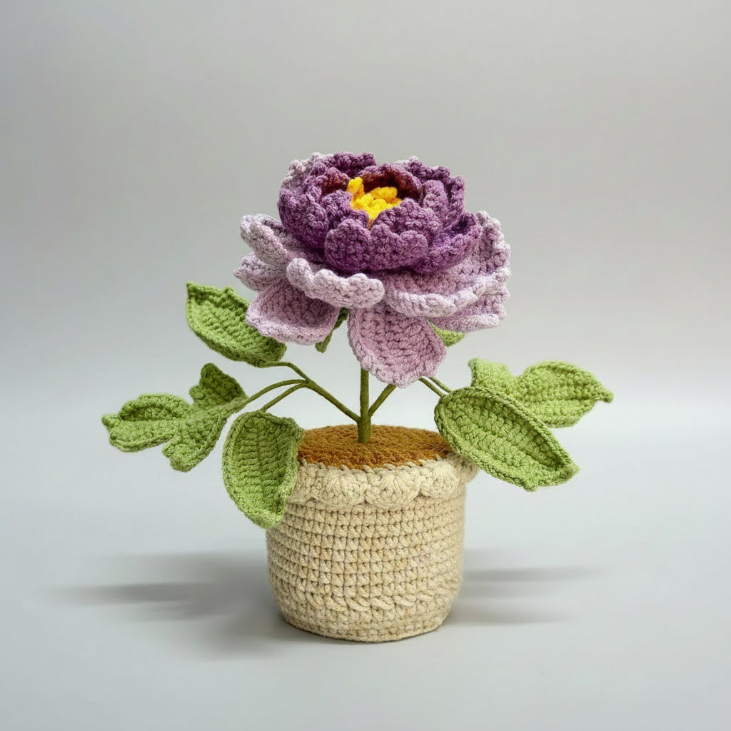 Handmade crochet peony in beige pot, purple and pale pink flower with green leaves