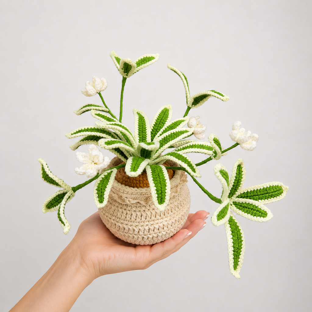 Handmade crochet snake plant with green-and-white yarn leaves in beige pot, held in hand