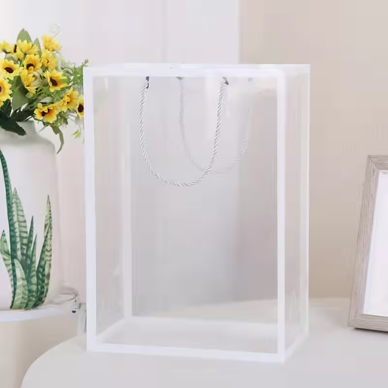 White gift bag with twisted rope handles, for crochet bouquet packaging
