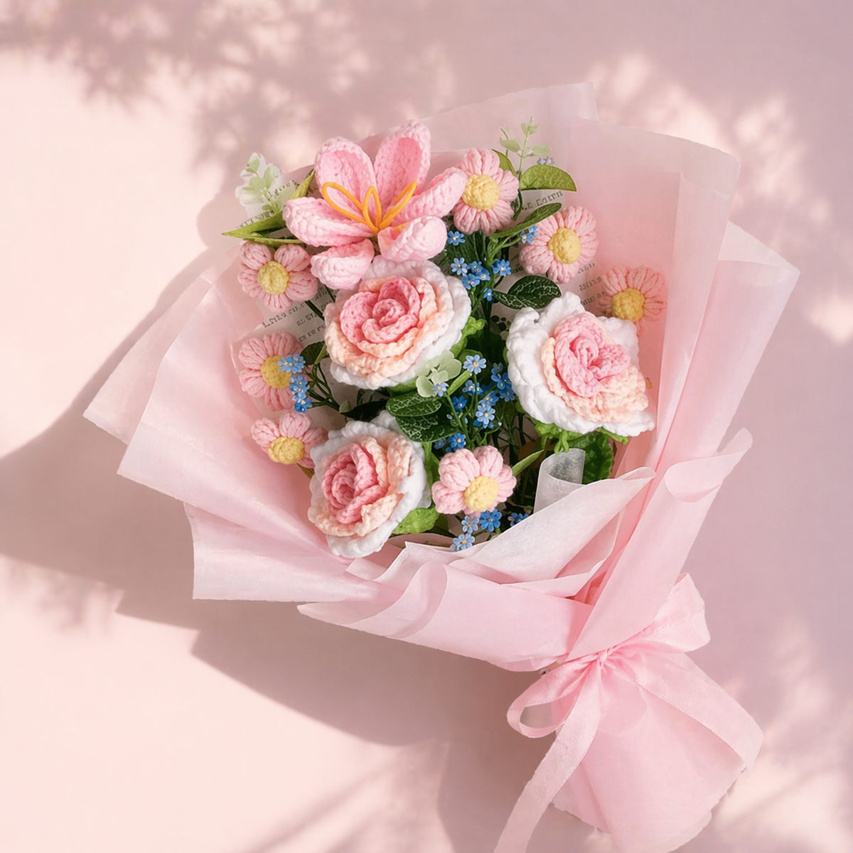 Handmade crocheted flower bouquet with pink and white roses, tulips, and small daisies